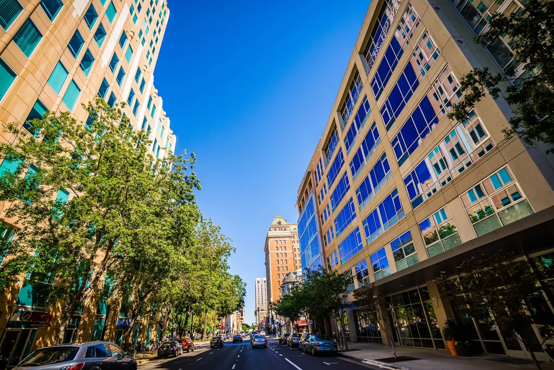 Downtown city scape looking down a street with tall buildings on either side