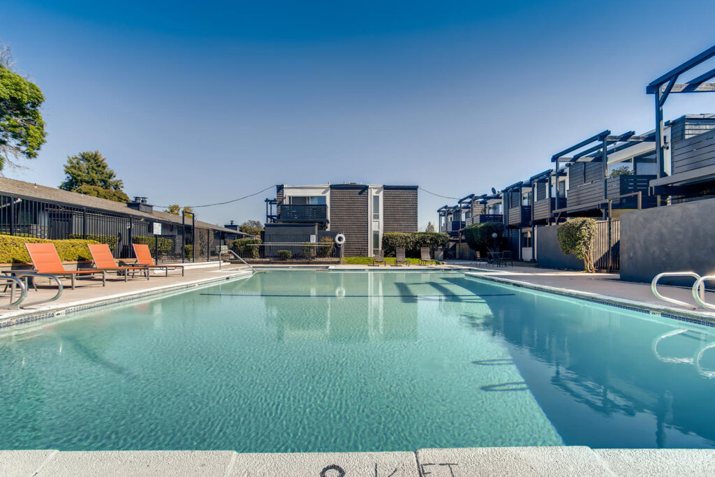 Pool with deck seating at Westwood apartments for rent in Carmichael, CA